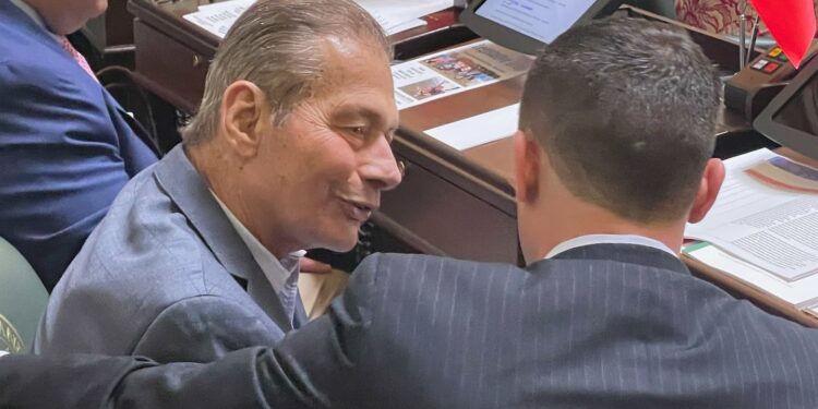 Rhode Island Senate President Dominick J. Ruggerio, left, speaks with Senator Jake Bissaillon prior to a Senate session earlier this year.