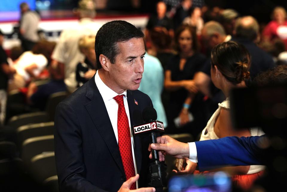 U.S. Senate candidate Bernie Moreno speaks to reporters before a rally for Ohio Sen. JD Vance at Middletown High School in July.