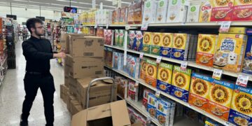 A Hy-Vee employee stocks cereal boxes on the shelves at the 26th Street location in Sioux Falls, S.D. on Sept. 6, 2024. Initiated Measure 28 seeks to eliminate the state sales tax on groceries in South Dakota, but questions about the measure persist.