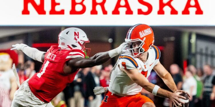 Sep 20, 2024; Lincoln, Nebraska, USA; Nebraska Cornhuskers defensive lineman Jimari Butler (1) grabs the face mask of Illinois Fighting Illini quarterback Luke Altmyer (9) during the second quarter at Memorial Stadium. Mandatory Credit: Dylan Widger-Imagn Images