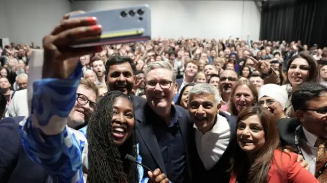 Prime Minister Sir Keir Starmer takes a selfie with Dawn Butler, MP for Brent East and Mayor of London Sadiq Khan at a reception during the Labour Party Conference in Liverpool.