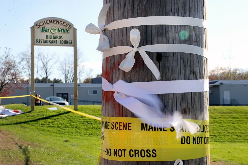 White ribbons placed on a telephone pole blew in the wind at Schemengees Bar and Grille after the mass shooting.