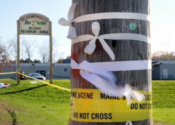 White ribbons placed on a telephone pole blew in the wind at Schemengees Bar and Grille after the mass shooting.