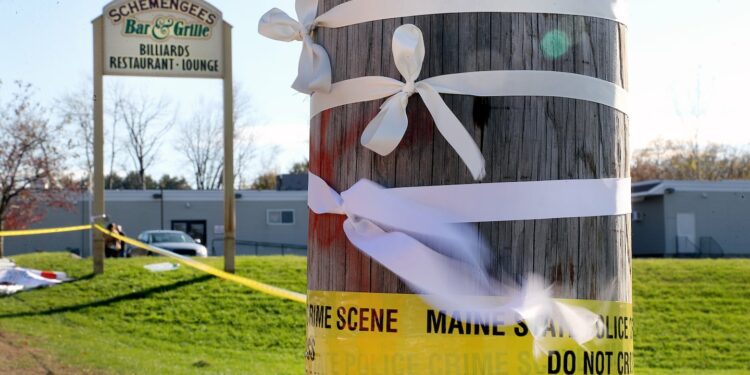 White ribbons placed on a telephone pole blew in the wind at Schemengees Bar and Grille after the mass shooting.