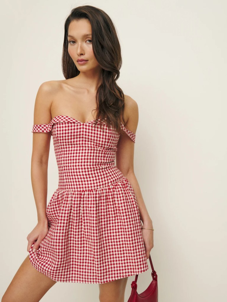 model wearing red and white checkered off the shoulder dress from reformation