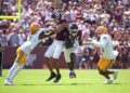 Sep 7, 2024; College Station, Texas, USA; Texas A&M Aggies running back Le'Veon Moss (8) runs the ball while wide receiver Noah Thomas (3) blocks McNeese State Cowboys defensive back Levi Wyatt (2) during the first quarter at Kyle Field. Mandatory Credit: Dustin Safranek-Imagn Images