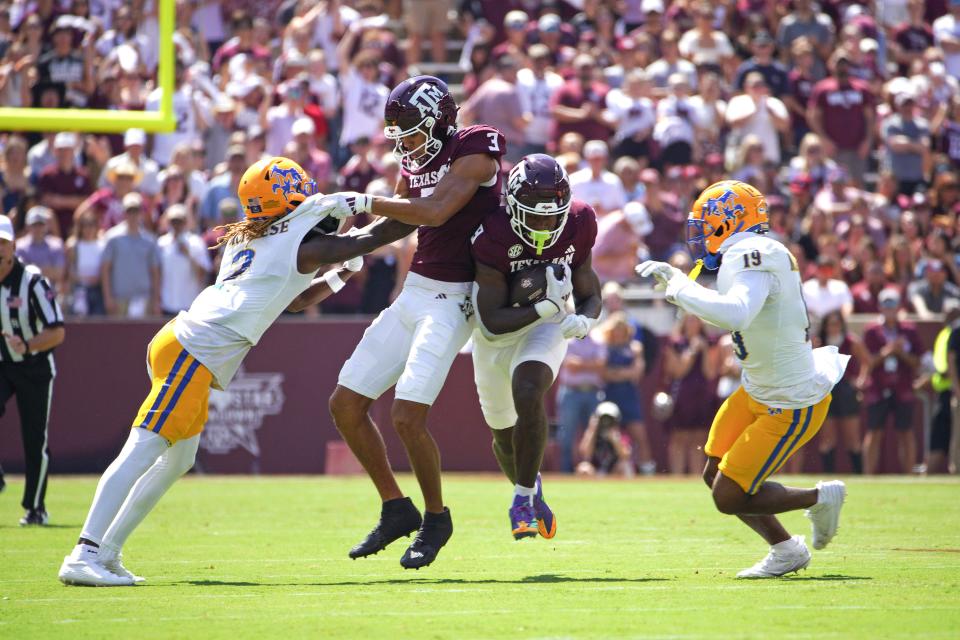 Sep 7, 2024; College Station, Texas, USA; Texas A&M Aggies running back Le'Veon Moss (8) runs the ball while wide receiver Noah Thomas (3) blocks McNeese State Cowboys defensive back Levi Wyatt (2) during the first quarter at Kyle Field. Mandatory Credit: Dustin Safranek-Imagn Images