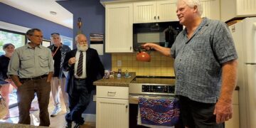 John Snell describing his new induction stove at an event highlighting energy efficiency - KEVIN MCCALLUM ©️ SEVEN DAYS