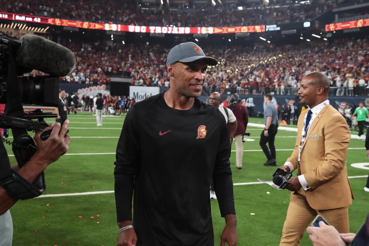 USC defensive coordinator D'Anton Lynn walks on the field after the Trojans' win over LSU at Allegiant Stadium.