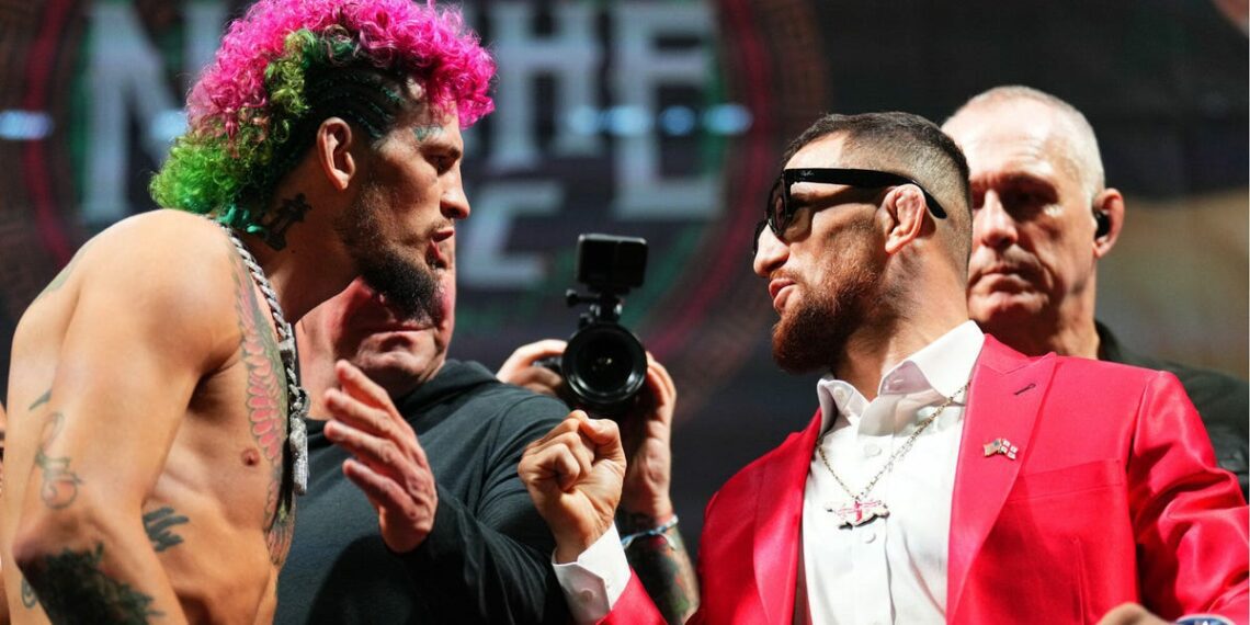 UFC fighters Sean O'Malley and Merab Dvalishvili facing each other, arguing.