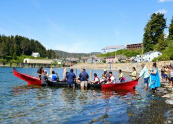 Angoon students prepare to paddle the unity canoe they built with master carver Wayne Price on June 19, 2023. It is the first canoe of its kind since the U.S. Navy bombardment of Angoon in 1882 that destroyed all the villages canoes. The Navy plans to issue apologies to Kake and Angoon residents in the fall of 2024. (Claire Stremple/Alaska Beacon)