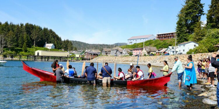 Angoon students prepare to paddle the unity canoe they built with master carver Wayne Price on June 19, 2023. It is the first canoe of its kind since the U.S. Navy bombardment of Angoon in 1882 that destroyed all the villages canoes. The Navy plans to issue apologies to Kake and Angoon residents in the fall of 2024. (Claire Stremple/Alaska Beacon)