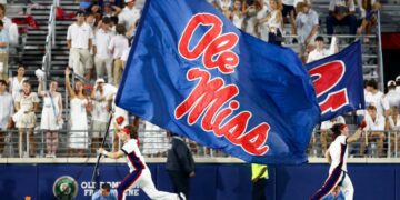 Aug 31, 2024; Oxford, Mississippi, USA; Mississippi Rebels Cheerleaders run the Ole Miss flag across the field after a touchdown during the second half against the Furman Paladins at Vaught-Hemingway Stadium. Mandatory Credit: Petre Thomas-USA TODAY Sports