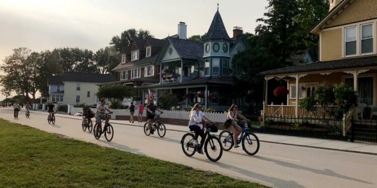 People ride bicycles on Mackinac Island on Friday, July 26, 2024.