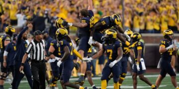 Michigan players celebrate a stop on fourth down against the...