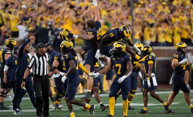 Michigan players celebrate a stop on fourth down against the...