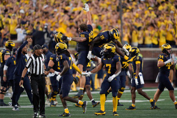 Michigan players celebrate a stop on fourth down against the...