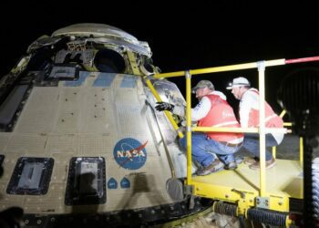 Boeing and NASA teams work around NASA's Boeing Starliner spacecraft after it landed uncrewed on Friday at White Sands, N.M. NASA Photo by Aubrey Gemignani/UPI