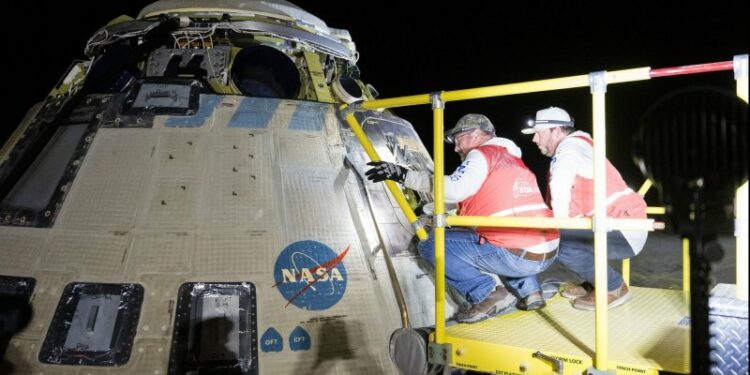 Boeing and NASA teams work around NASA's Boeing Starliner spacecraft after it landed uncrewed on Friday at White Sands, N.M. NASA Photo by Aubrey Gemignani/UPI