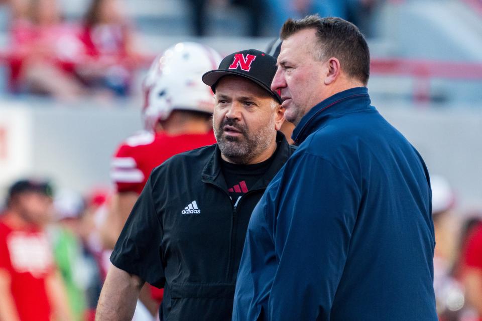 Sep 20, 2024; Lincoln, Nebraska, USA; Nebraska Cornhuskers head coach Matt Rhule and Illinois Fighting Illini head coach Bret Bielema talk before a game at Memorial Stadium. Mandatory Credit: Dylan Widger-Imagn Images