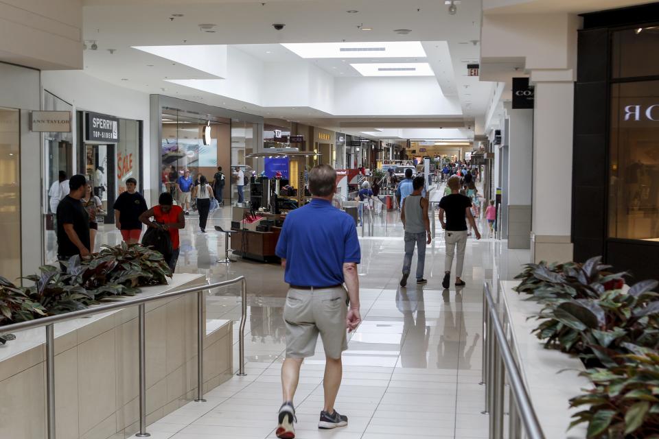 Shoppers stroll through Kenwood Towne Centre near the Apple Store on Thursday, June 22, 2017. The Enquirer/Shae Combs