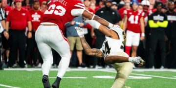 Sep 7, 2024; Lincoln, Nebraska, USA; Nebraska Cornhuskers running back Dante Dowdell (23) stiff arms Colorado Buffaloes cornerback Preston Hodge (24) during the third quarter at Memorial Stadium. Mandatory Credit: Dylan Widger-Imagn Images