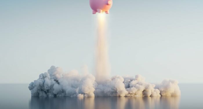 A piggy bank blasts off like a rocket.