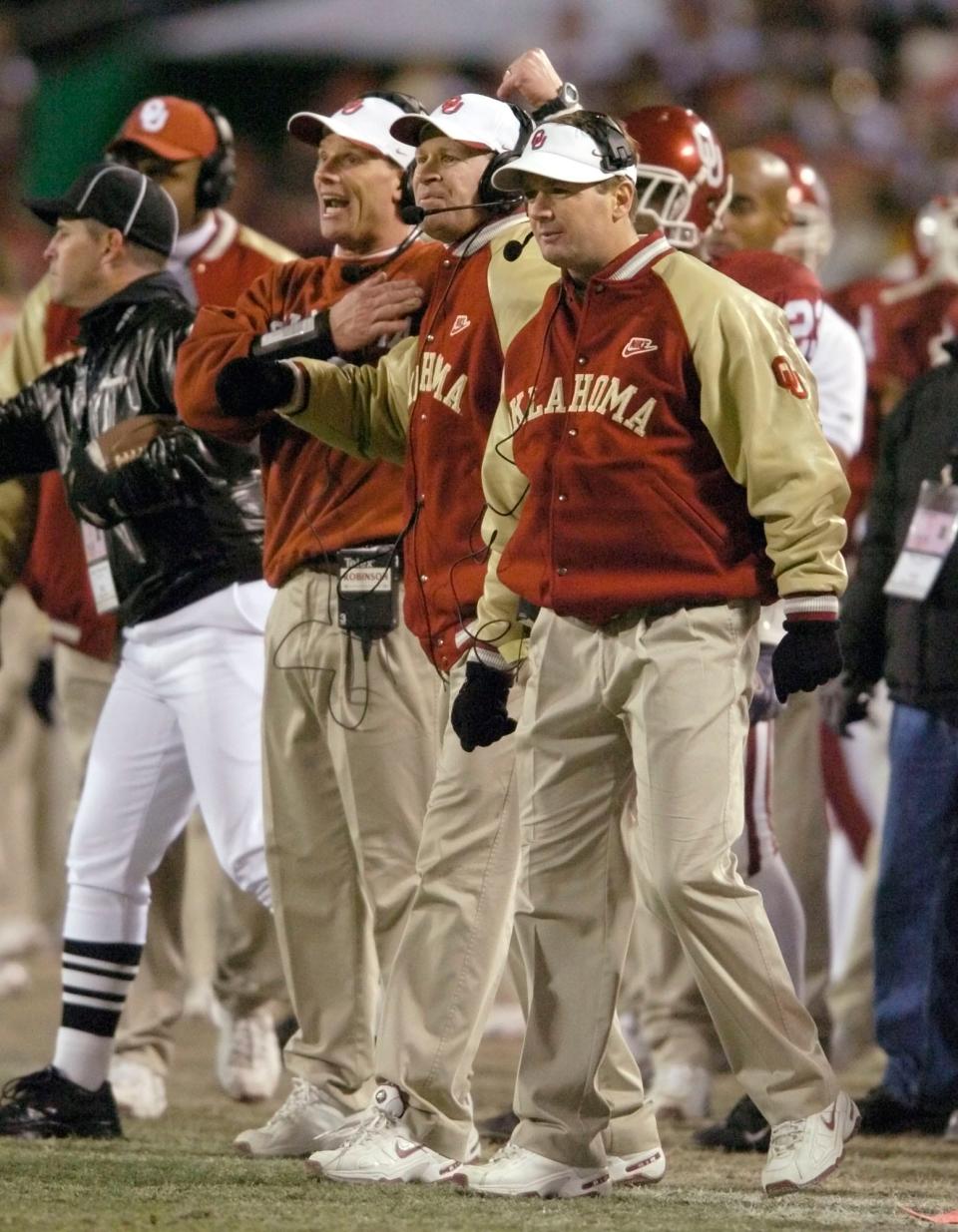 Kansas City, MO. USA. Saturday, December 6, 2003: Big 12 Championship College Football Arrowhead Stadium, University of Oklahoma vs Kansas State University (KSU):  OU coaches Brent Venables, Mike and Bob Stoops send signals to their defense.  Staff photo by Steve Sisney.