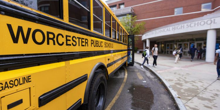 Students get off the school bus and file into Worcester Technical High School. (Jesse Costa/WBUR)