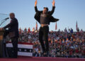 Elon Musk jumps on the stage as Republican presidential nominee Donald Trump speaks at a campaign rally in Butler, Pennsylvania, on October 5.