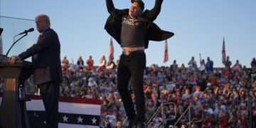 Elon Musk jumps on the stage as Republican presidential nominee Donald Trump speaks at a campaign rally in Butler, Pennsylvania, on October 5.