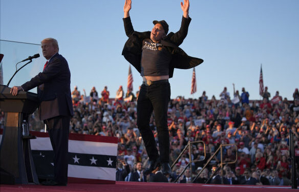 Elon Musk jumps on the stage as Republican presidential nominee Donald Trump speaks at a campaign rally in Butler, Pennsylvania, on October 5.