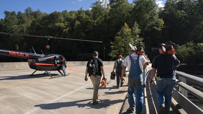 Emergency responders‌ work near⁢ Bat Cave after hurricane devastation.